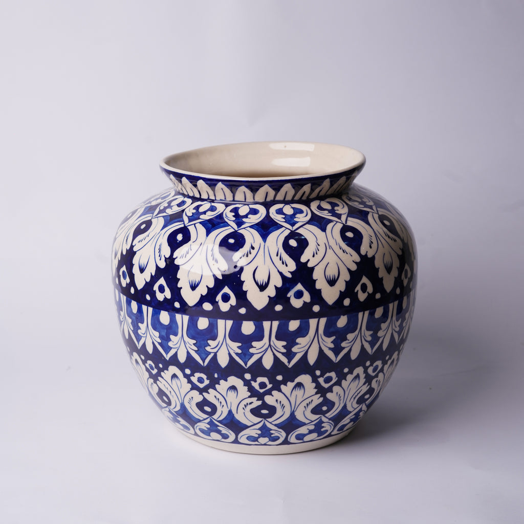Ceramic Multani blue pottery jar with blue and white floral pattern on a light gray background