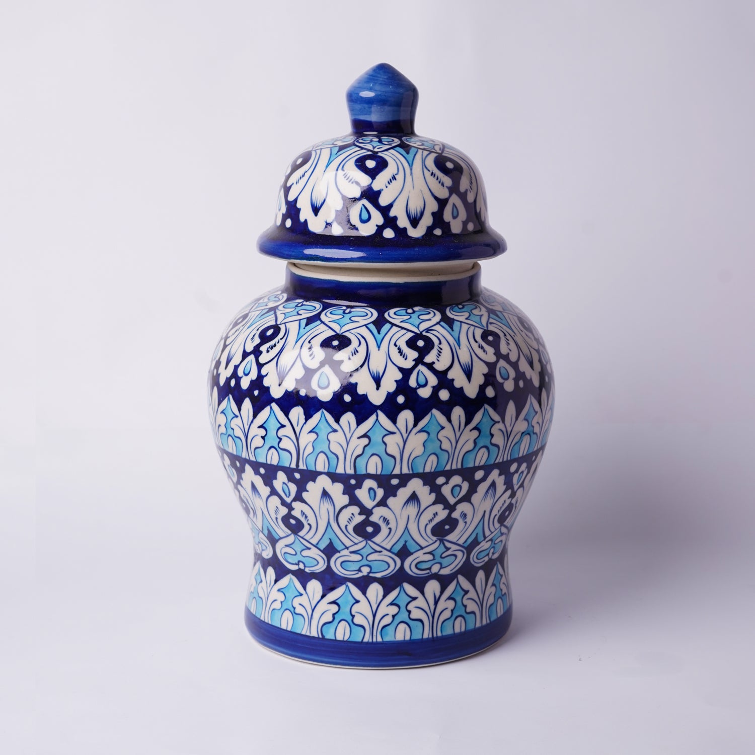 Ceramic multani blue pottery jar with blue and white floral patterns on a white background