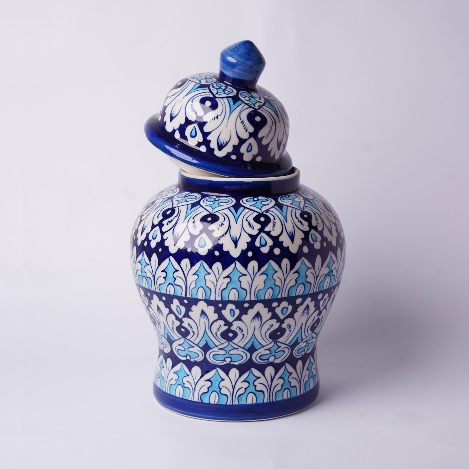Ceramic  multani blue pottery jar with blue and white floral patterns on a white background