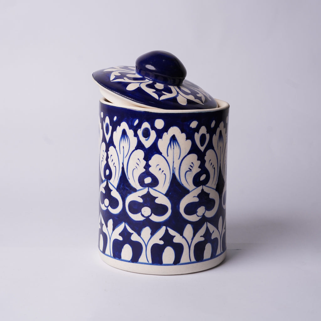 Ceramic Multani blue pottery jar with blue and white floral pattern on a light gray background
