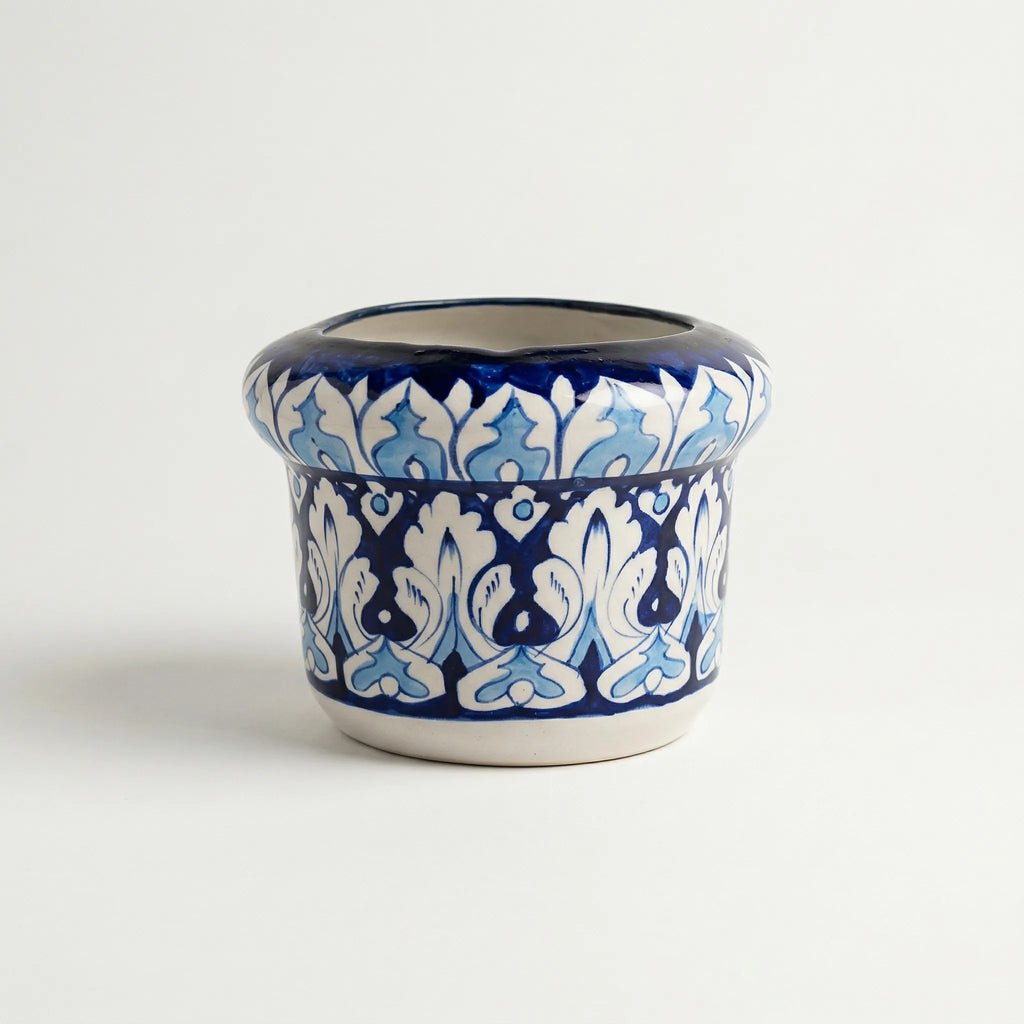 Blue pottery Ceramic pot with blue and white floral pattern on a white background