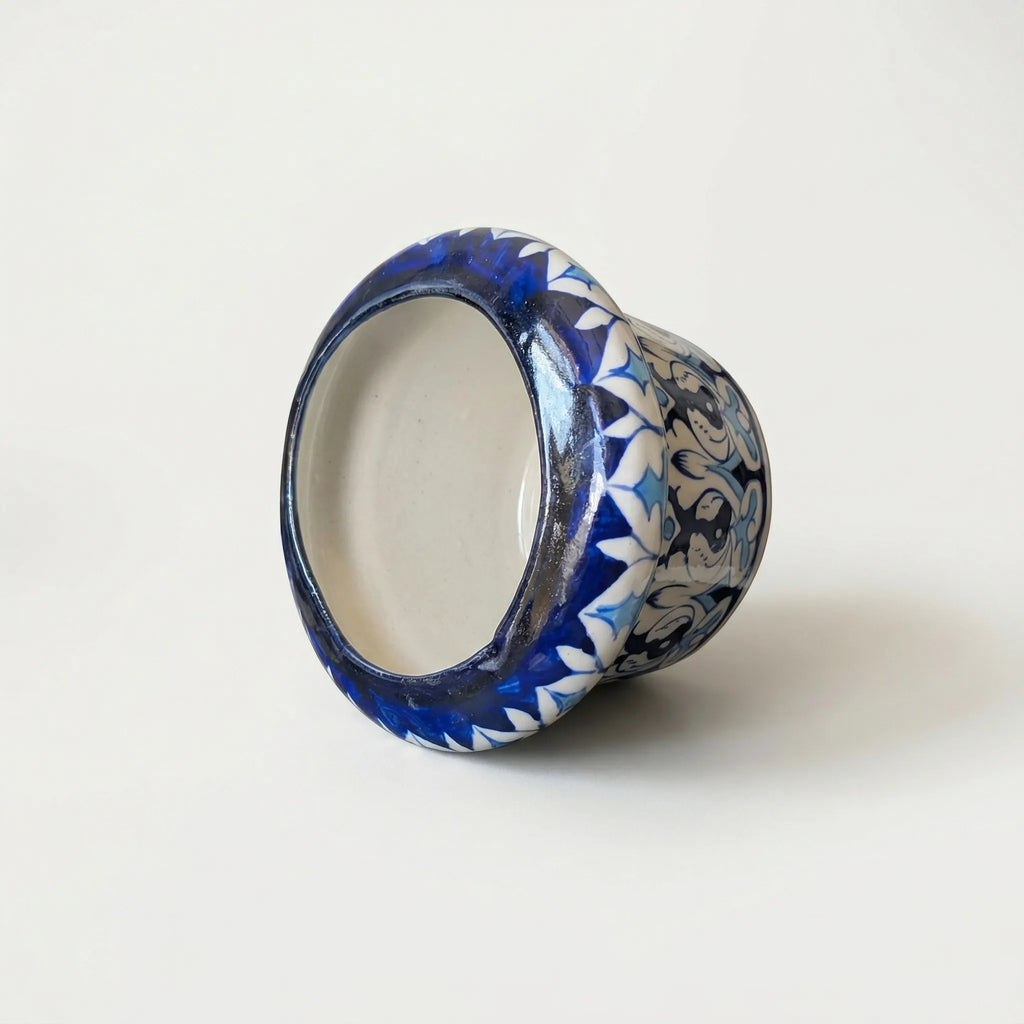 Blue pottery Ceramic planter placed sideways with blue and white floral pattern on a white background