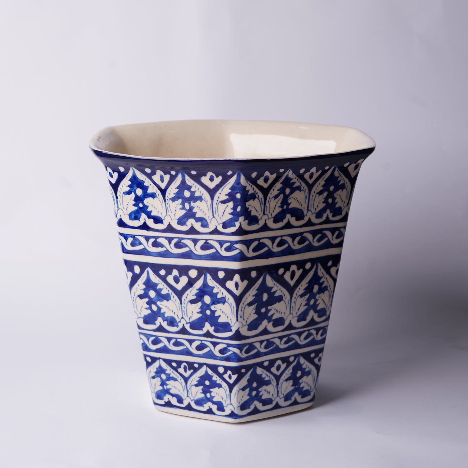 Ceramic Multani Blue pottery planter with blue and white geometric pattern on a gray background