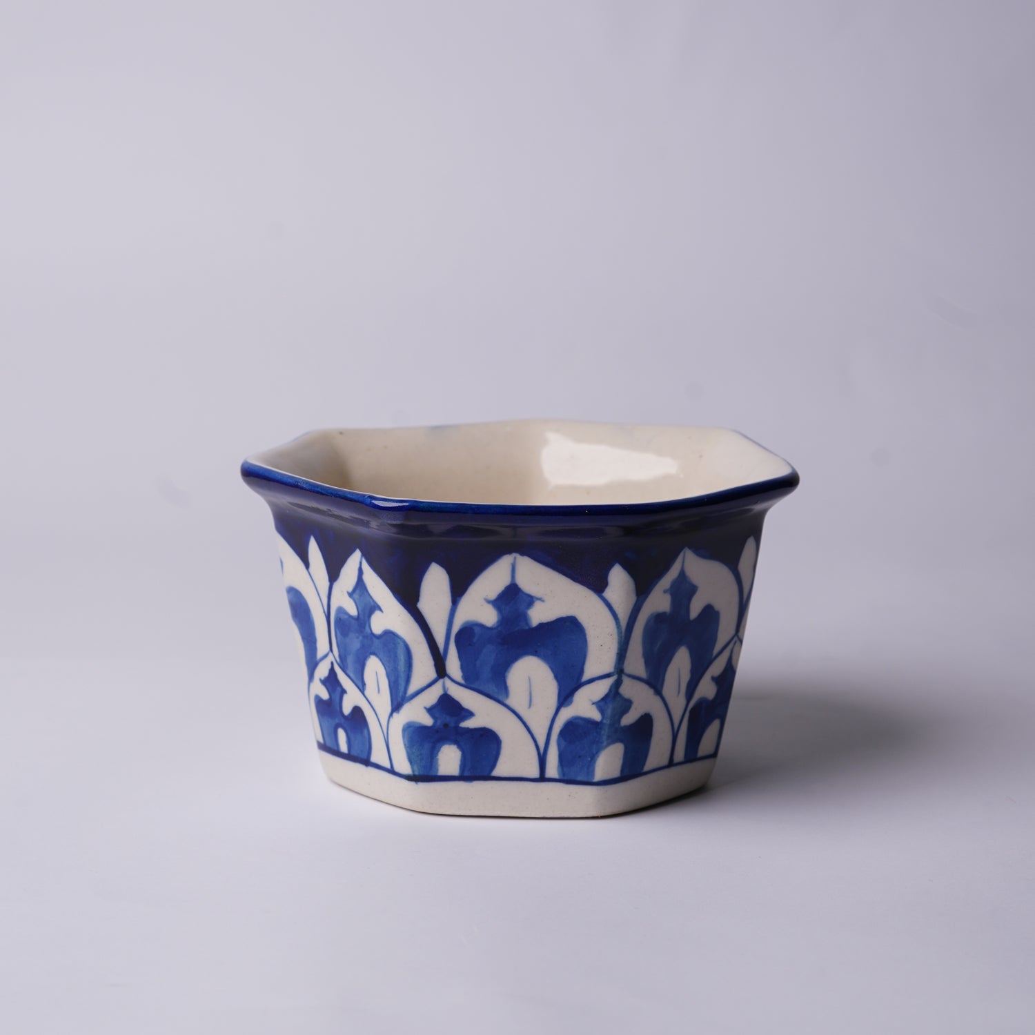 Ceramic multani blue pottery pot with blue and white floral patterns on a gray background