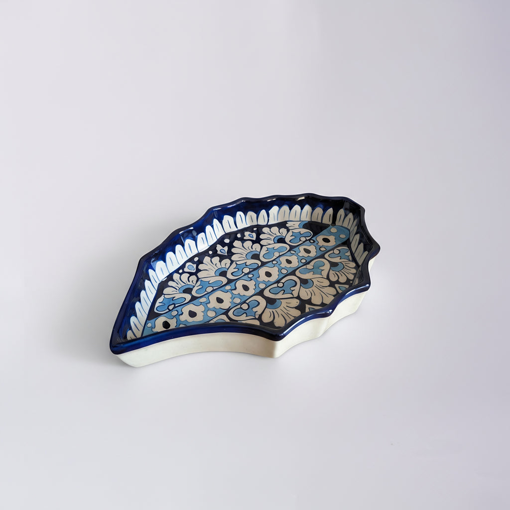 Handcrafted ceramic dish featuring layered blue botanical motifs — Pakistani artisan made