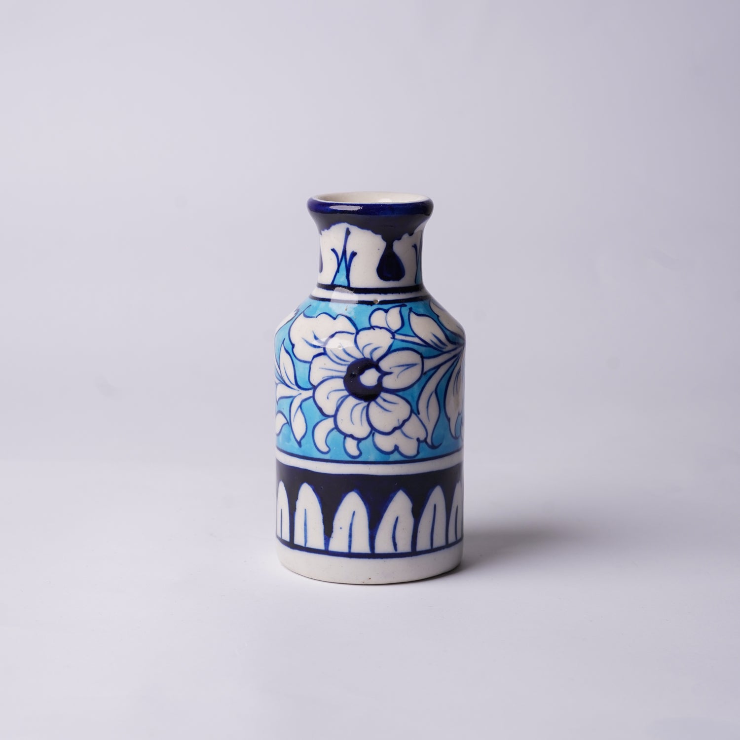 Ceramic multani blue pottery vase with blue and white floral design on a light gray background