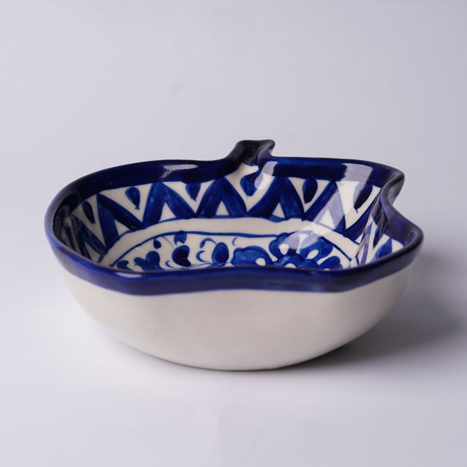 Ceramic multani blue pottery bowl with blue and white pattern on a light gray background