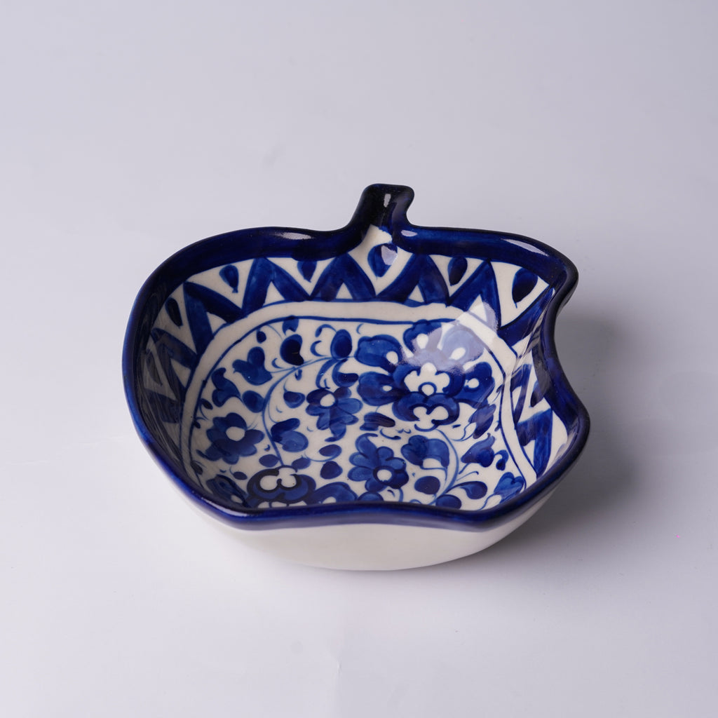 Ceramic multani blue pottery bowl with blue floral pattern on a white background