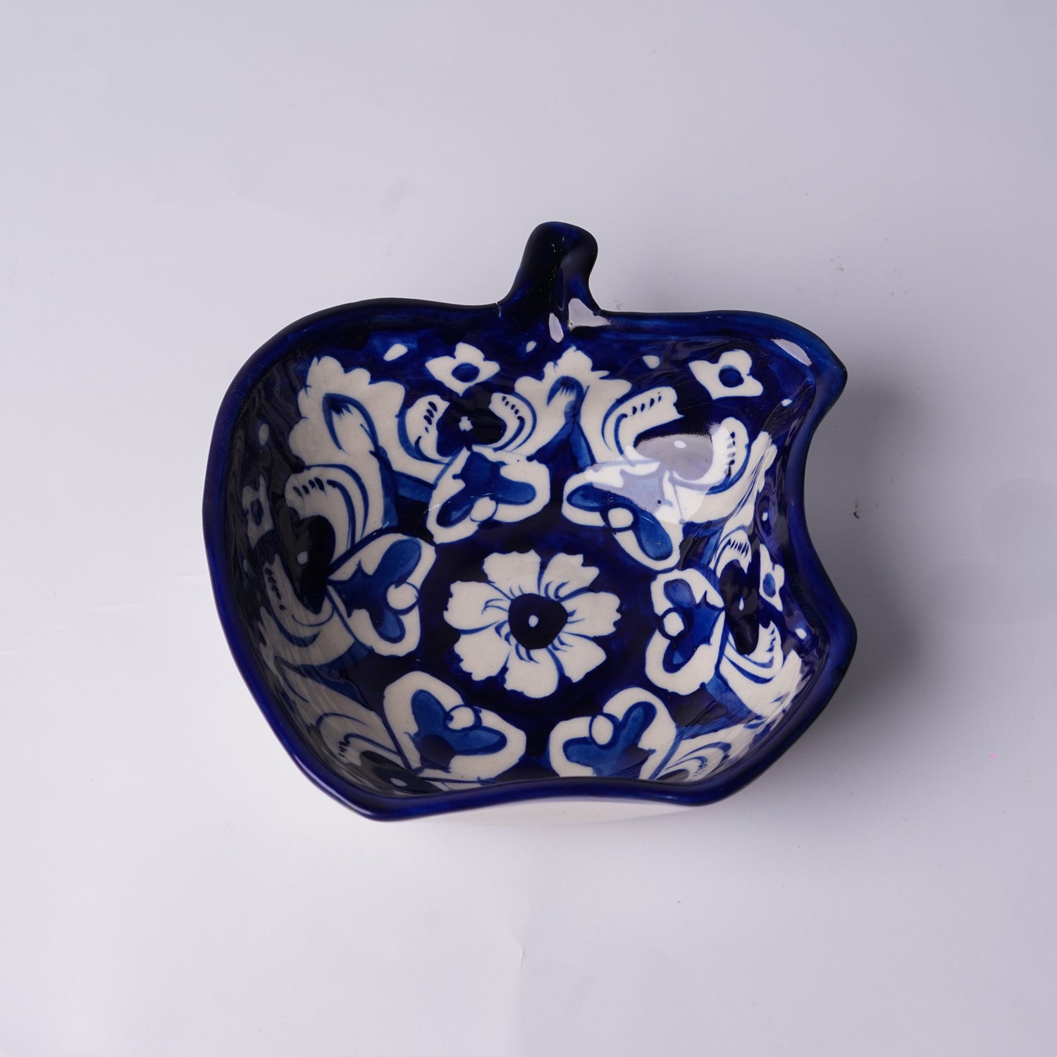 Ceramic multani blue pottery bowl with blue and white floral pattern on a white background