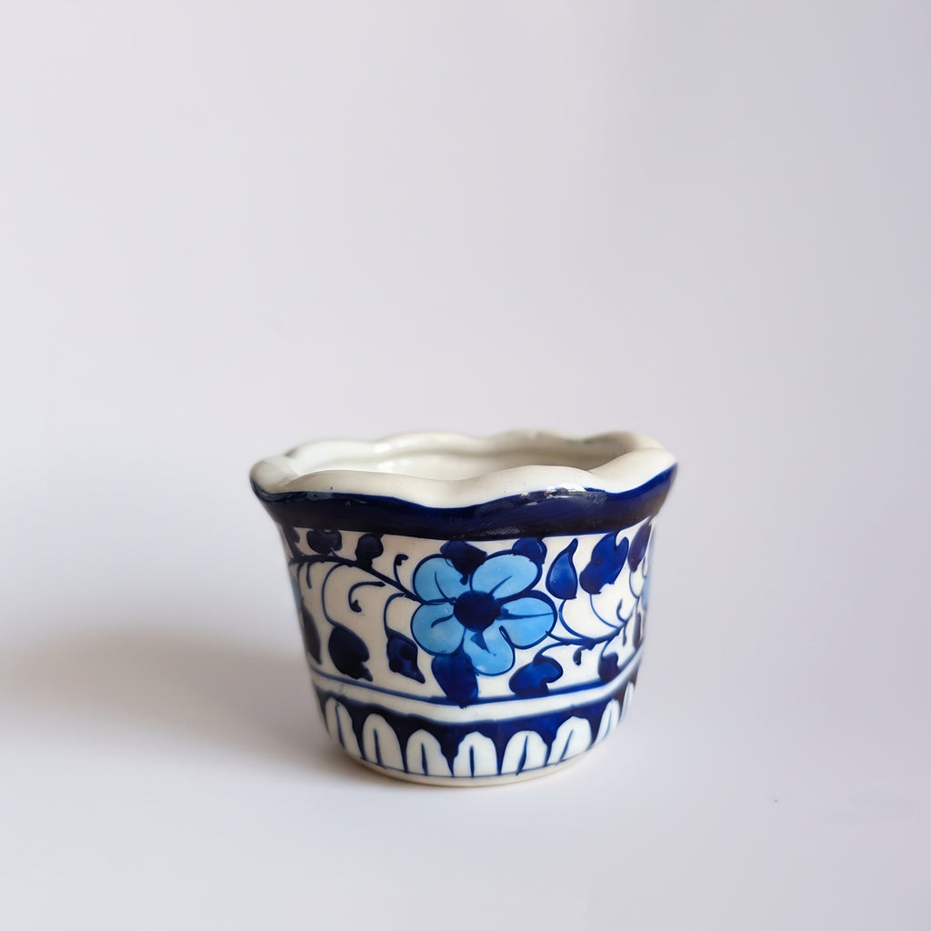 Blue pottery planter with wavy rim showing intricate floral patterns — Craftan Pakistan