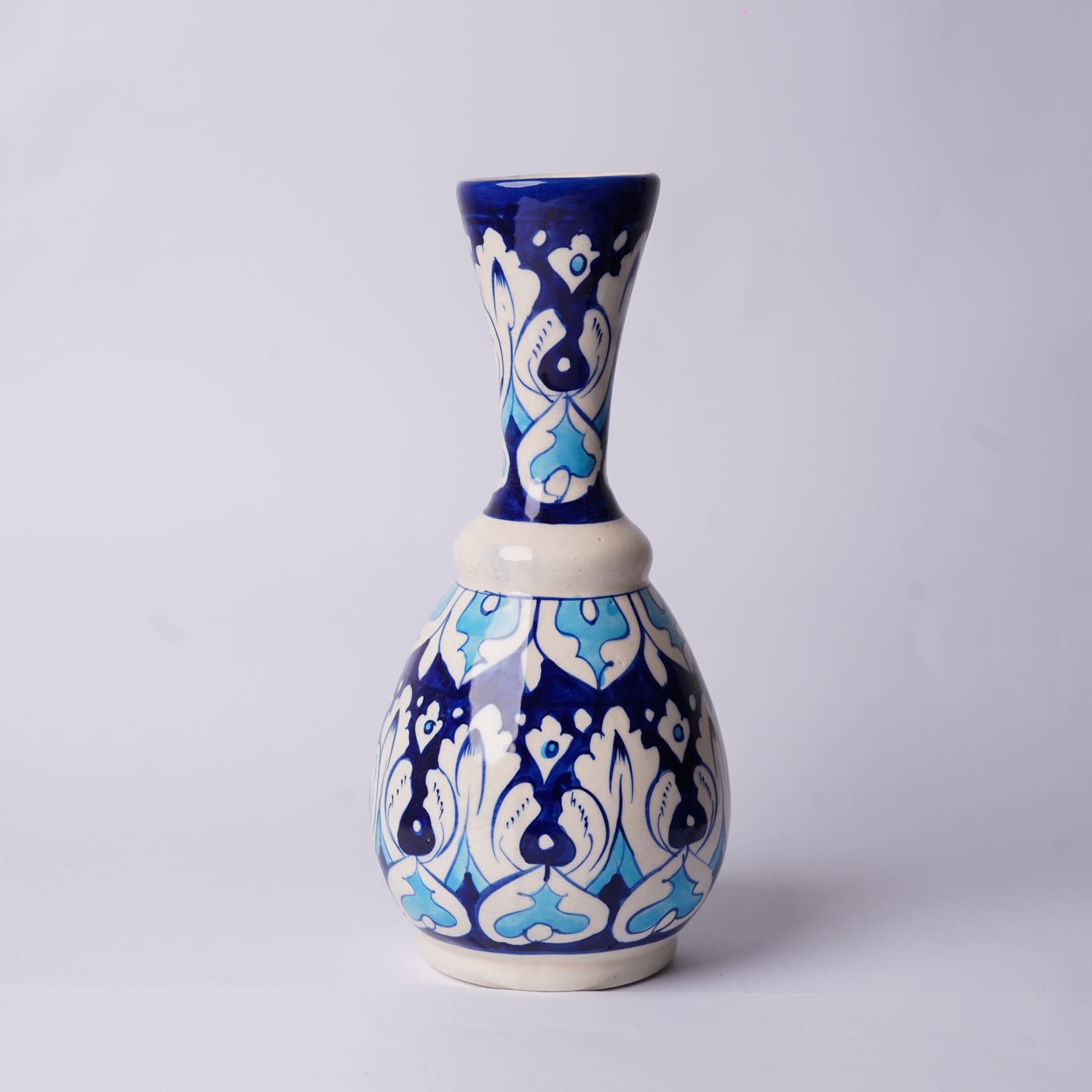 Ceramic multani blue pottery vase with blue and white pattern on a light gray background 
