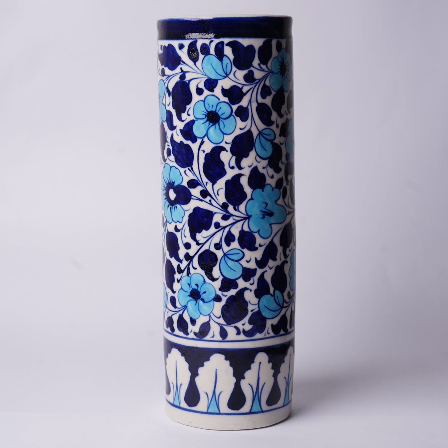 Cylindrical ceramic Multani Blue Pottery vase with blue floral pattern on a white background