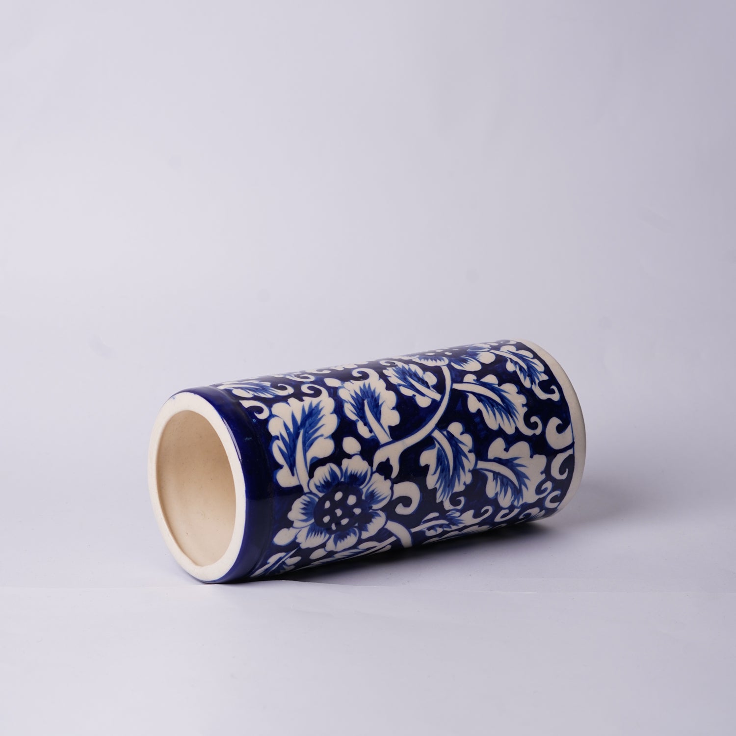 Cylindrical ceramic Multani Blue Pottery Vase with blue floral pattern on a light gray background