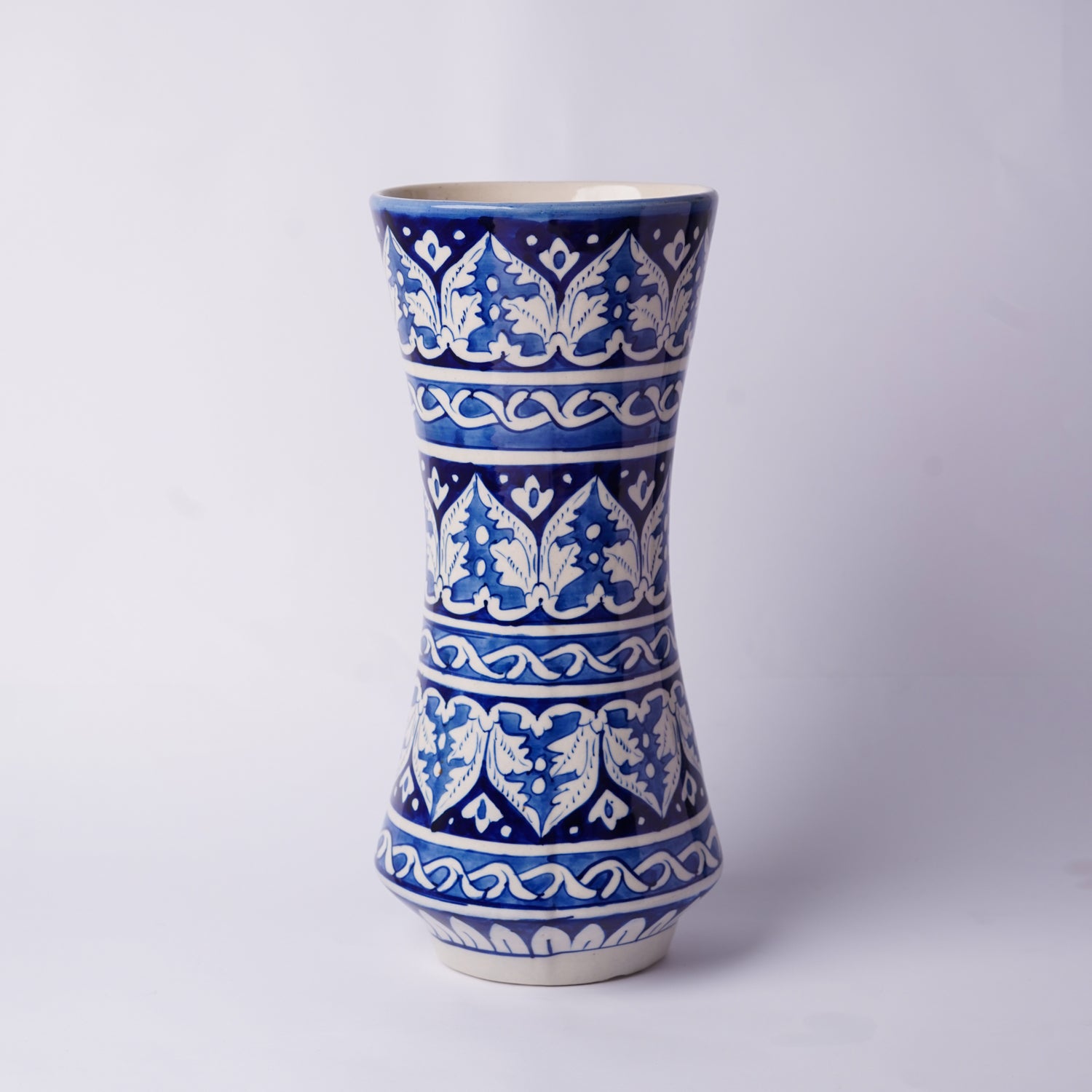 Ceramic Multani blue pottery vase with blue and white pattern on a light gray background