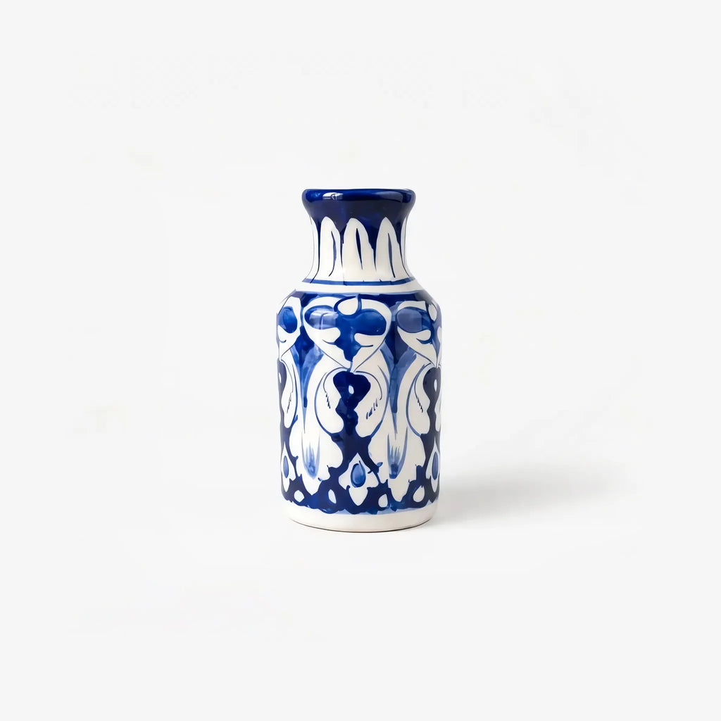6 inch blue pottery bottle vase with white arabesque on cobalt and a white petal neck