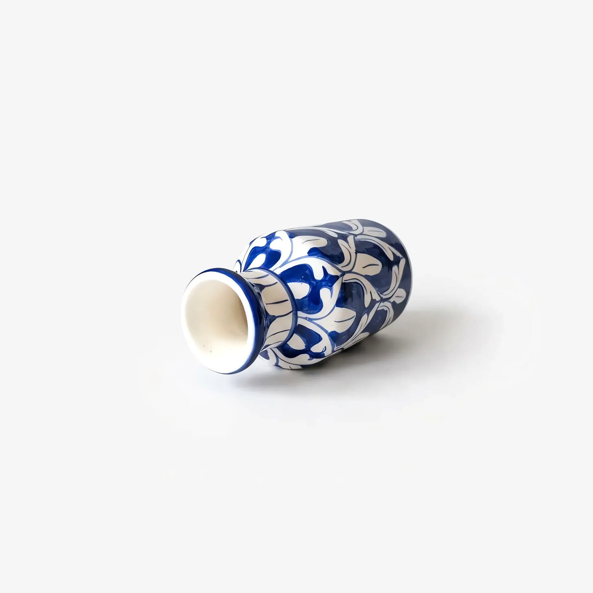 Blue pottery bottle vase lying on its side