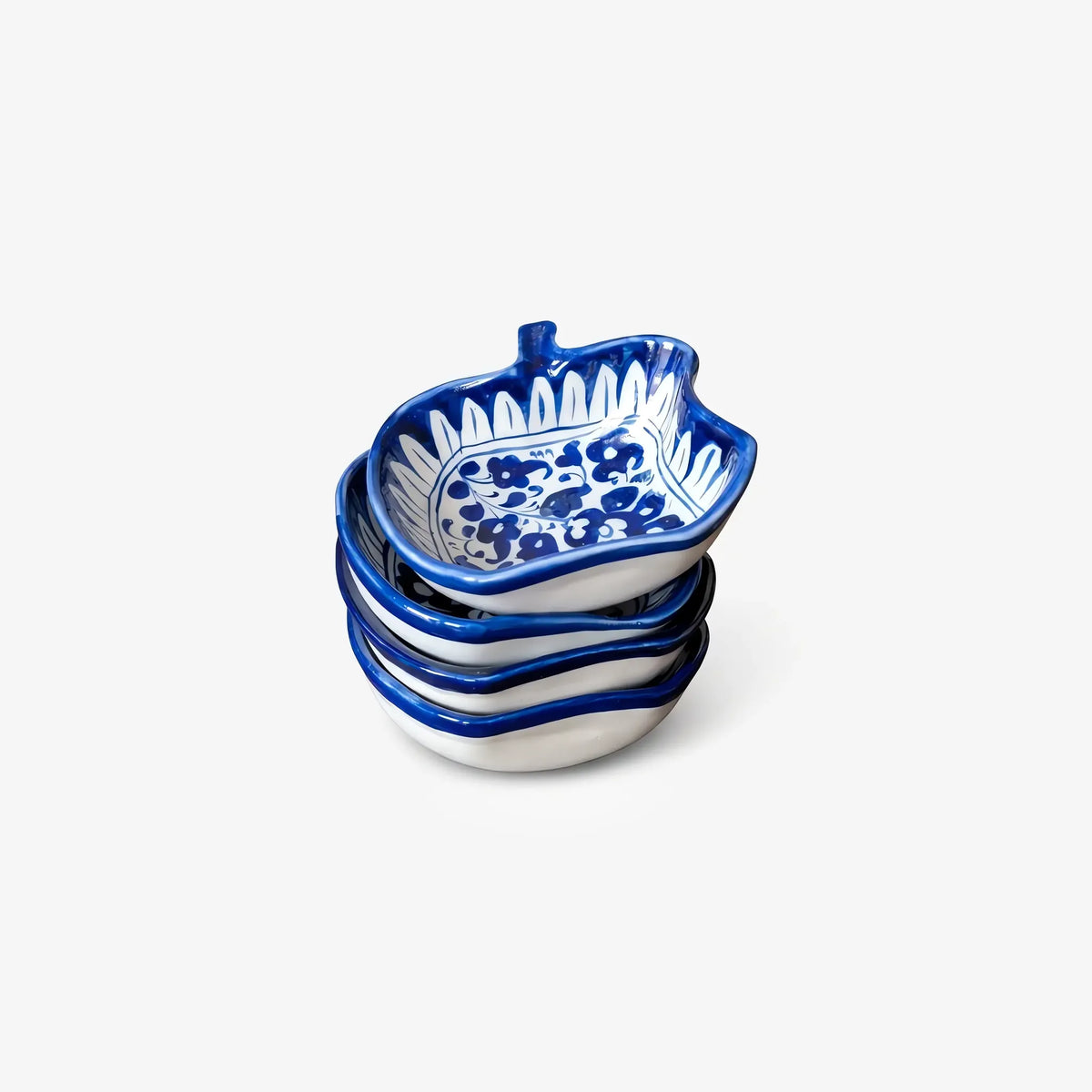 Stack of apple shaped blue pottery bowls