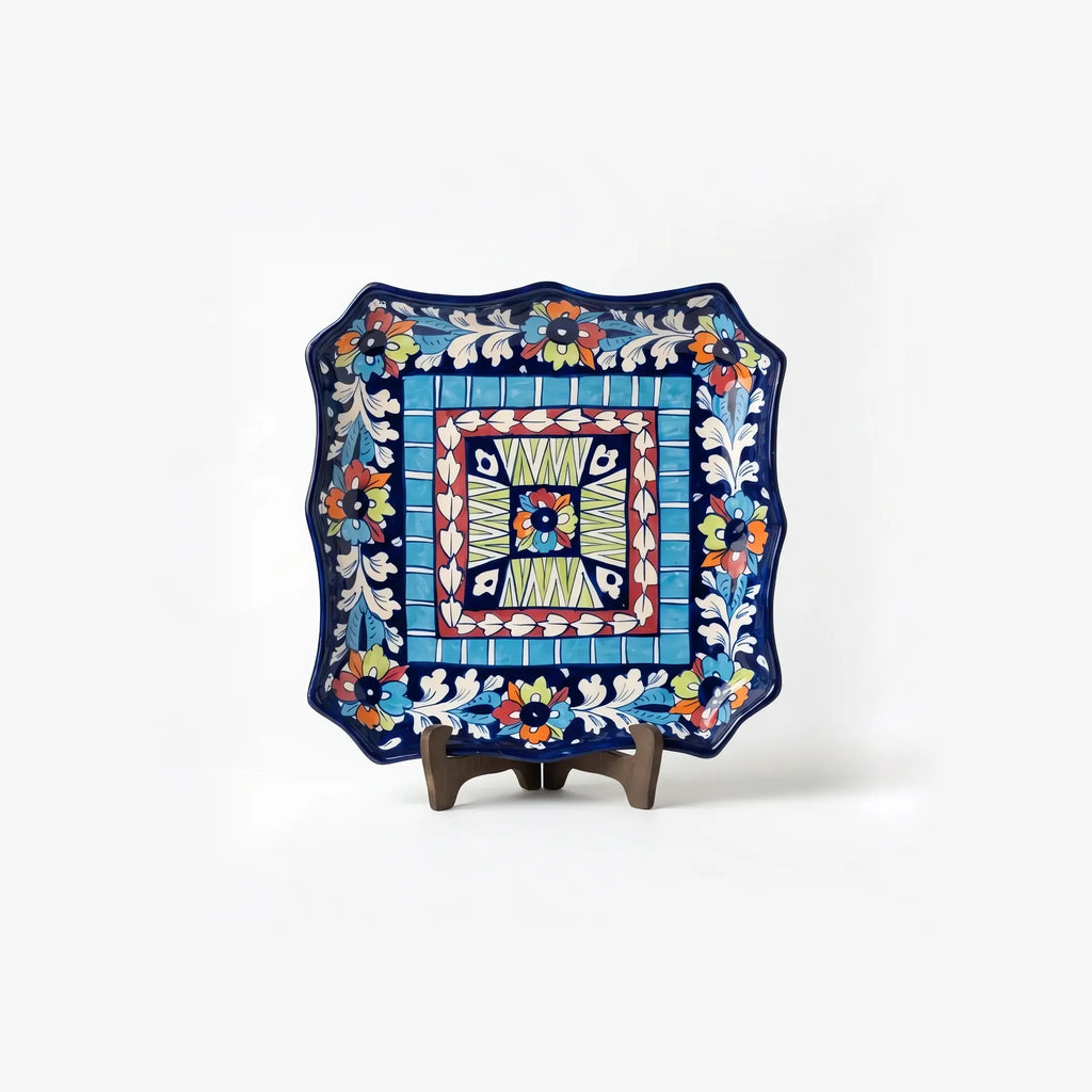 10.5 inch square multicolor blue pottery dish displayed on a stand