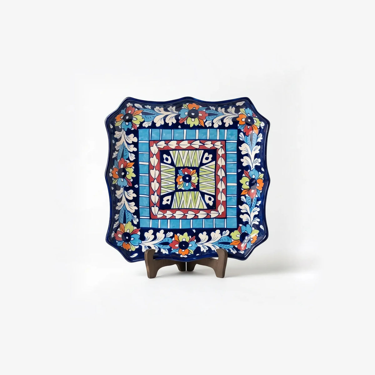 10.5 inch square multicolor blue pottery dish displayed on a stand