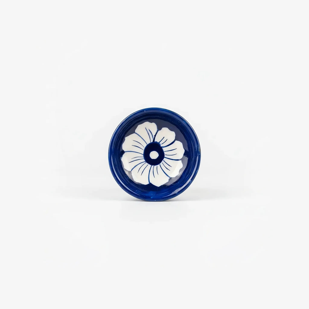 Top dish of the oil burner with a white flower on cobalt