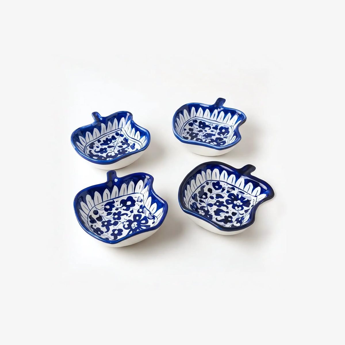 Four apple shaped blue pottery bowls together