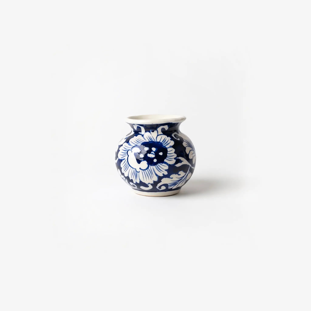 3 inch blue pottery garwi with a large white blossom on cobalt
