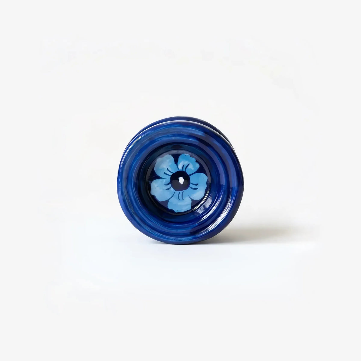 Top view of the candle stand cup with sky-blue flower