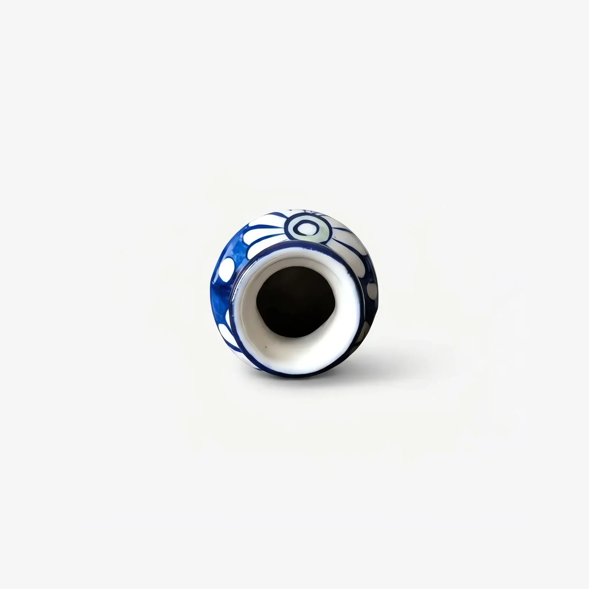Top view into the neck of the white daisy blue pottery bottle vase