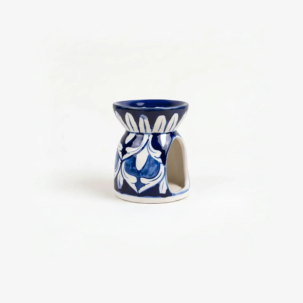 Blue pottery oil burner showing the arched tealight opening