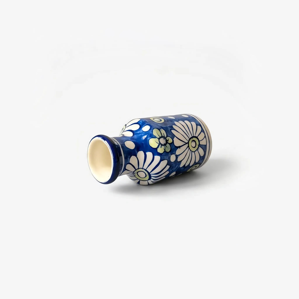 White daisy bottle vase lying on its side