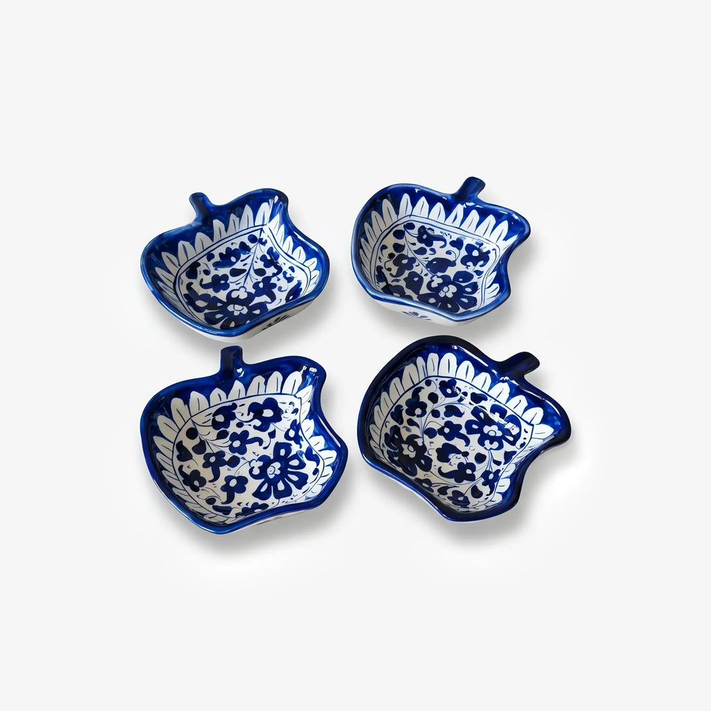 Four apple bowls arranged in a square, top view