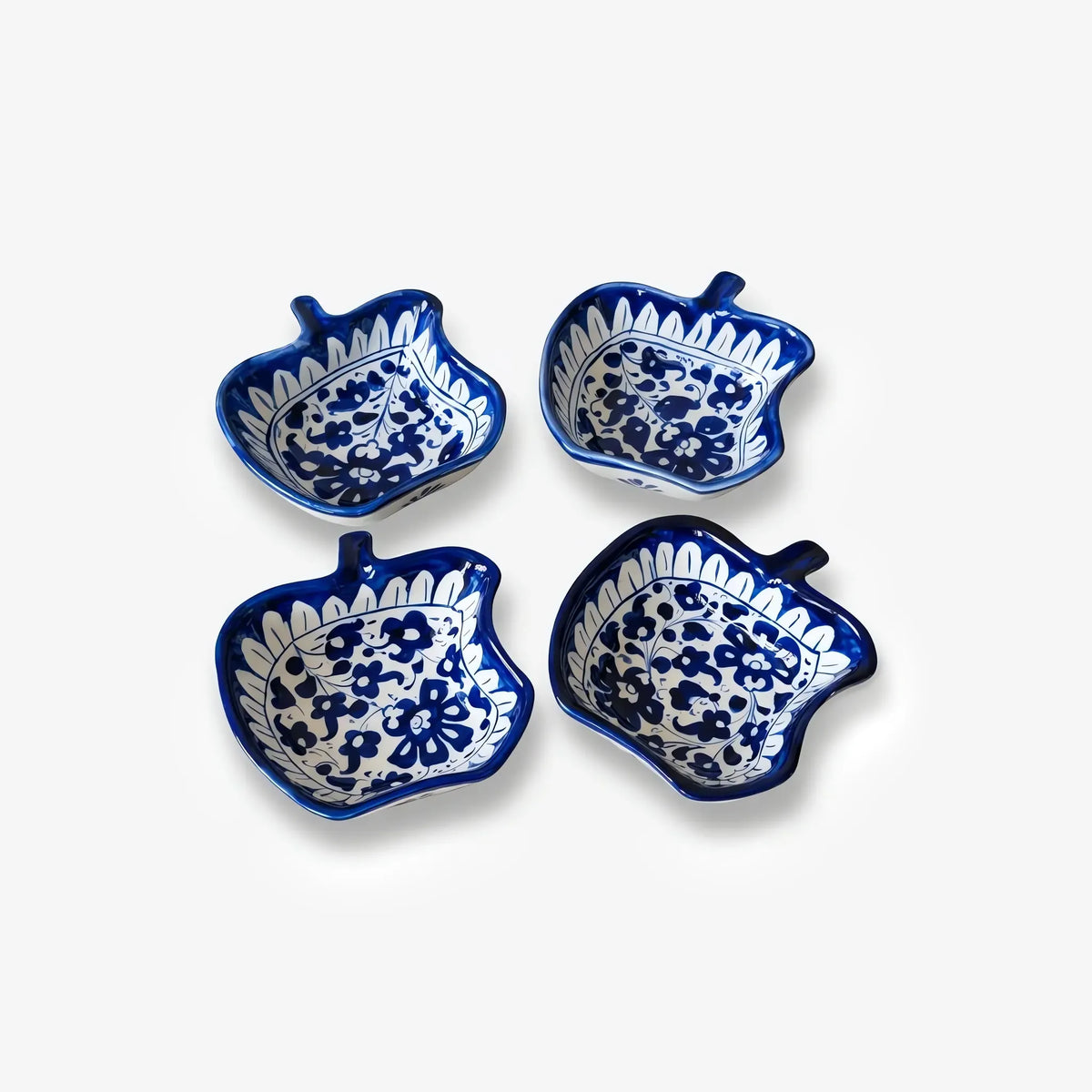 Four apple bowls arranged in a square, top view