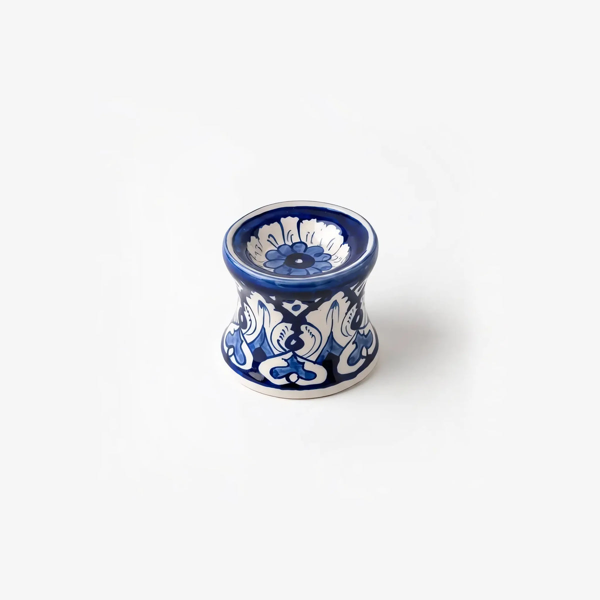 Blue pottery candle stand seen from above at an angle