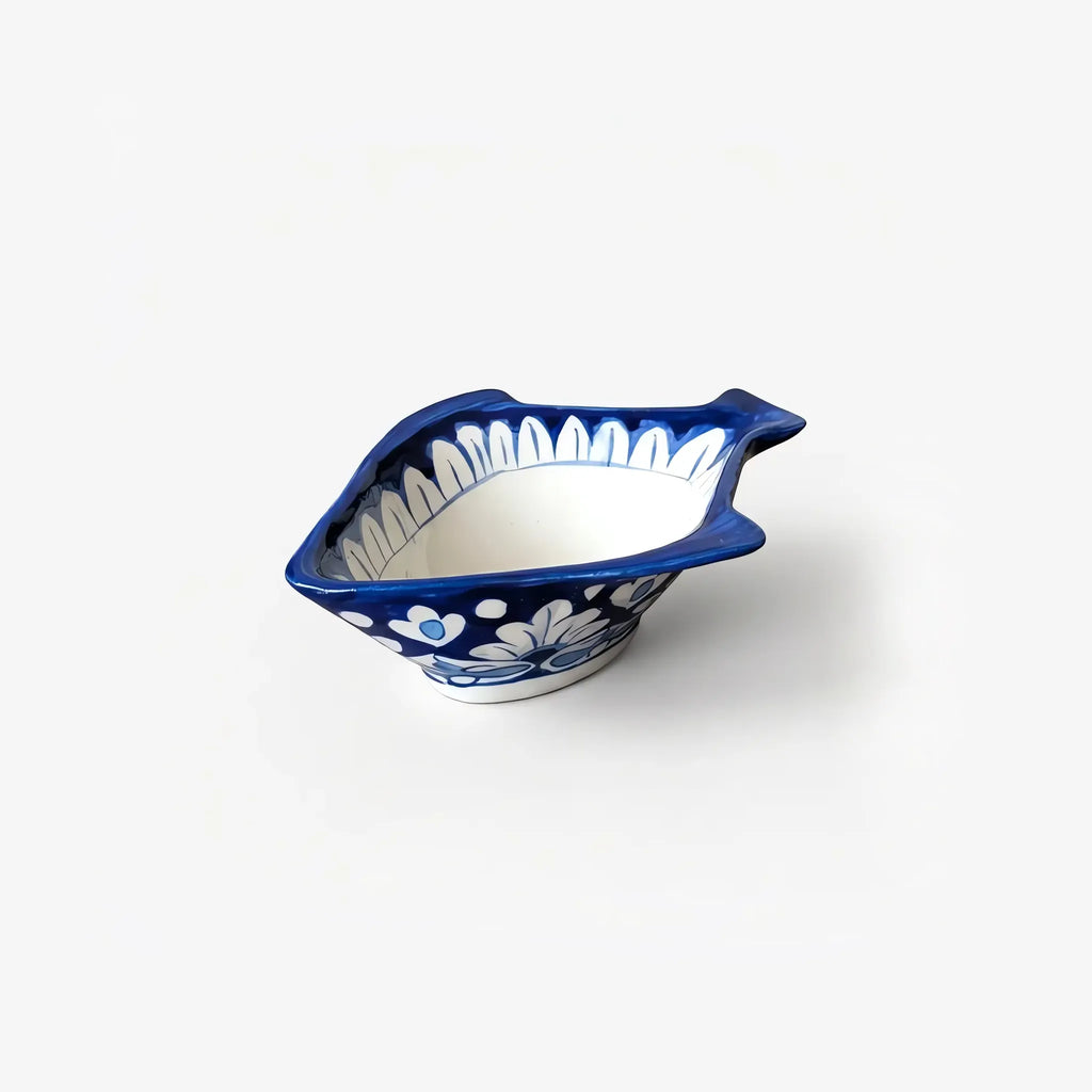 Blue pottery fish-shaped bowl with cream centre and white petal rim
