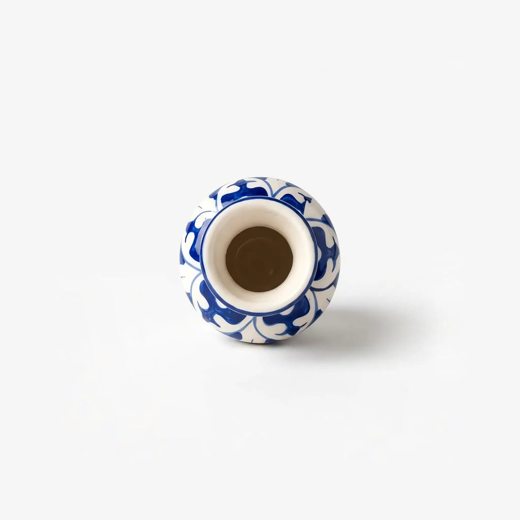 Top view into the glazed neck of the blue pottery bottle vase