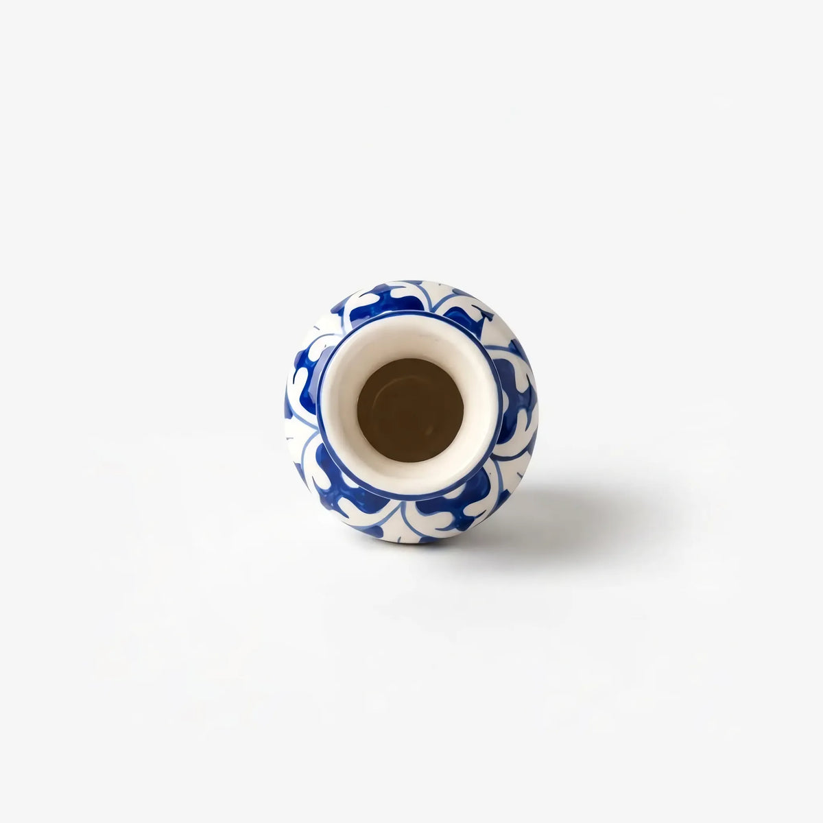 Top view into the glazed neck of the blue pottery bottle vase