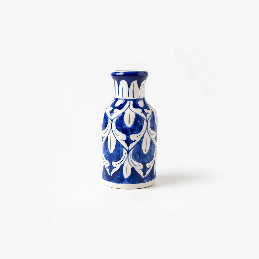 6 inch blue pottery bottle vase with white tulips and leaves on cobalt