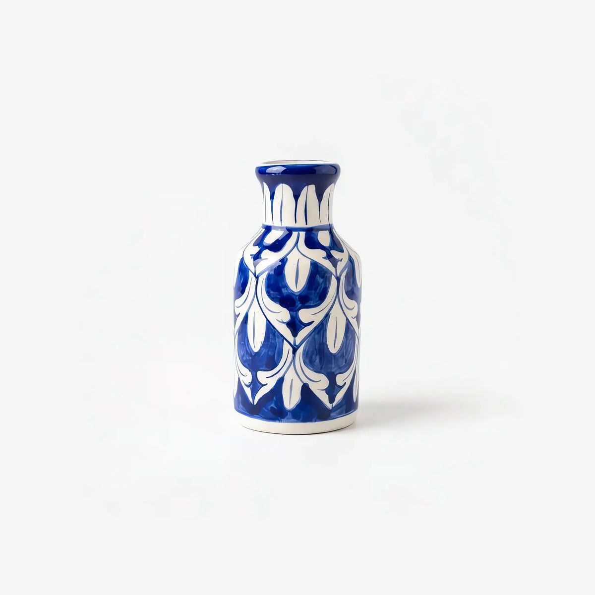 6 inch blue pottery bottle vase with white tulips and leaves on cobalt