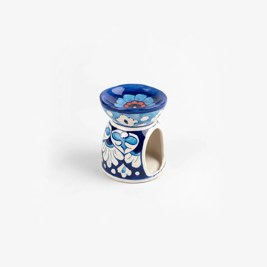 Blue pottery oil burner seen from above at an angle