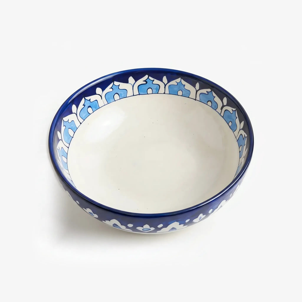 Large blue pottery serving bowl with cream inside