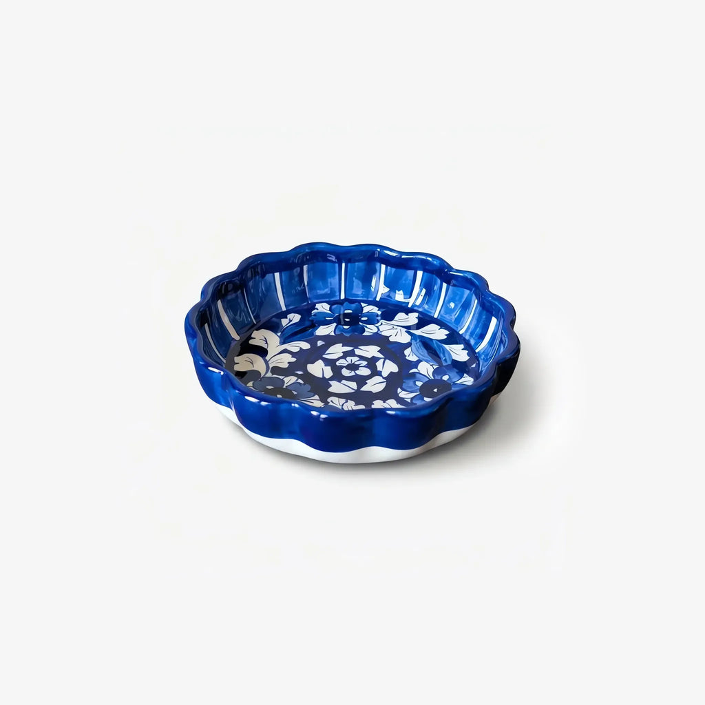 Cobalt apple pie dish with fluted scalloped rim, angled view