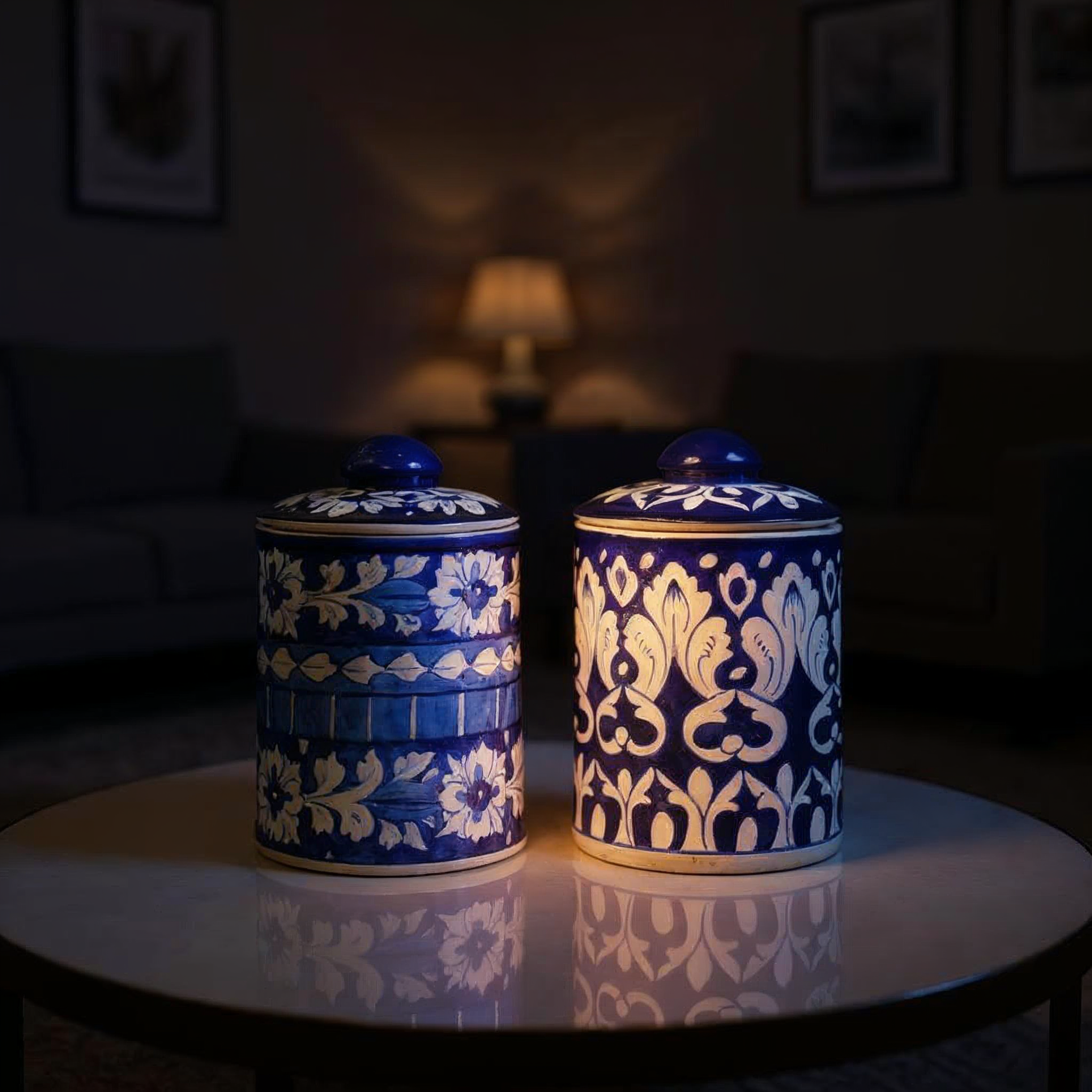 Two blue and white ceramic Multani Blue Pottery jars with intricate patterns on a dark background