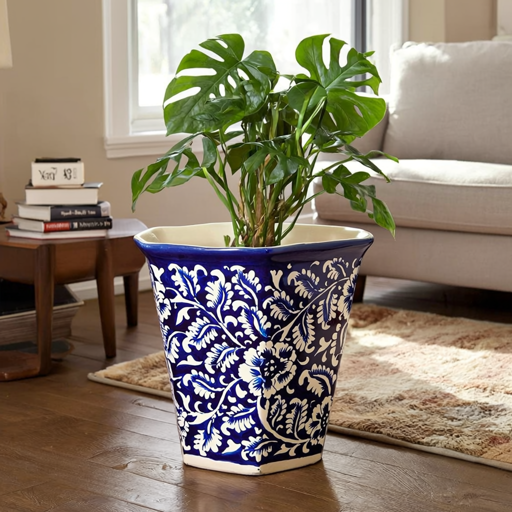 Blue and white patterned Multani Blue pottery planter with a green plant in a living room setting.